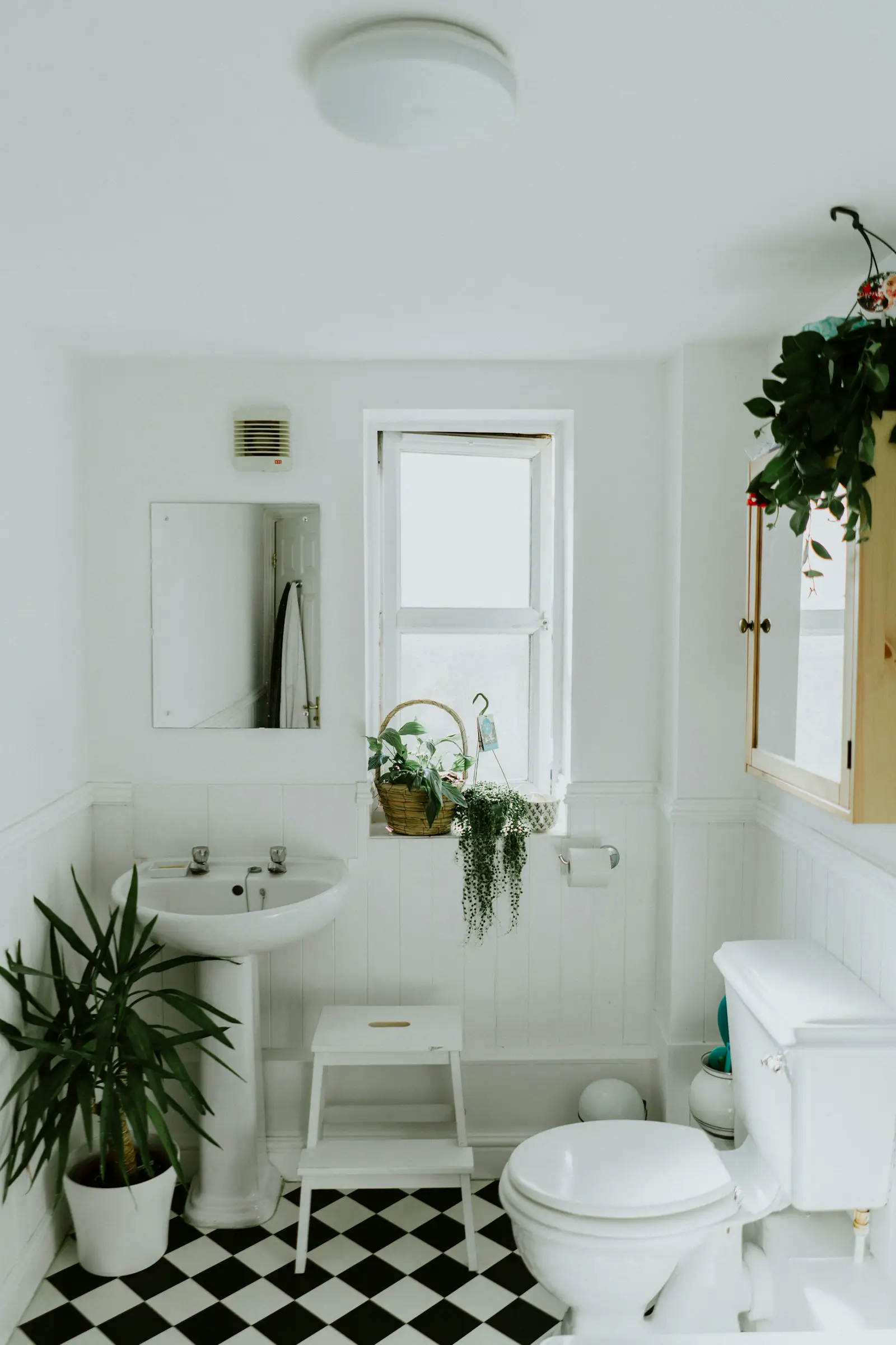 A small bathroom with a pedestal sink, a toilet, and a window. Shown on the Primary bath page for Arlington, TX.