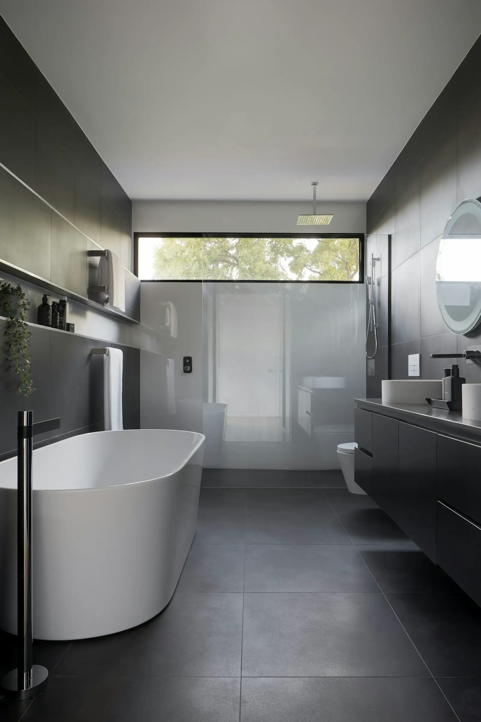 A bathroom with a tub, a glass shower, and a dark vanity. Shown on the Walk-in shower page for Arlington, TX.