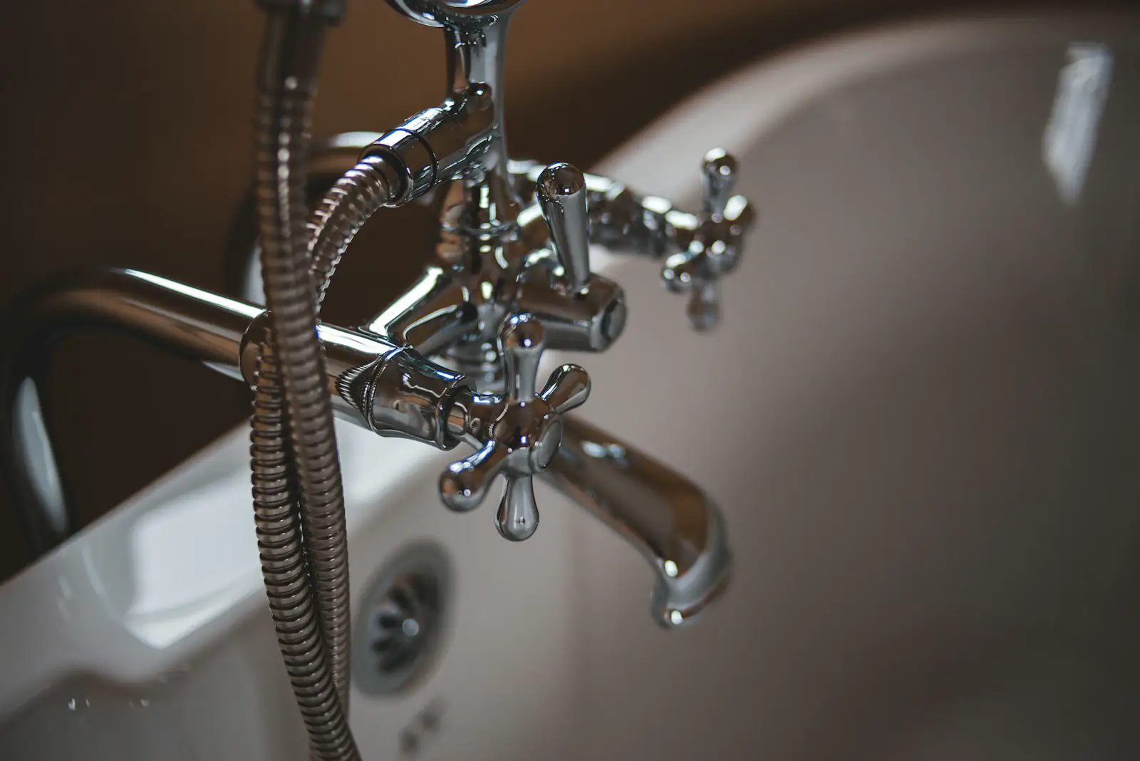 A chrome bathtub faucet and handheld sprayer. Shown on the Half bath page for Arlington, TX.